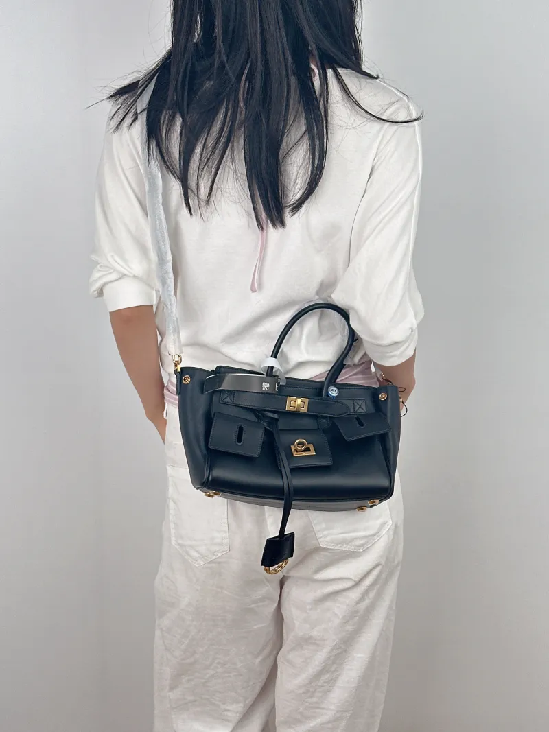 BALENCIAGA Crossbody Bag Bel air Black with Gold-Tone Hardware Calfskin Mini 23.5 × 8 × 17 cm — on-model view 3 of 3