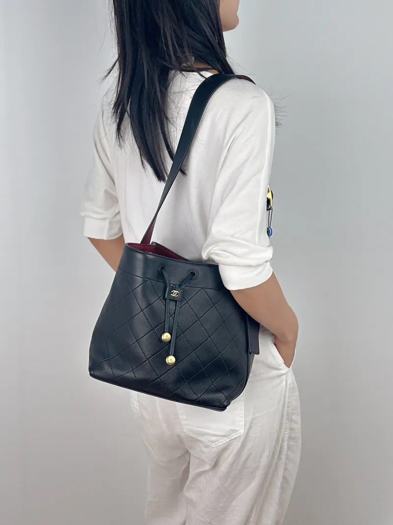 Chanel Shoulder Bag Bucket Bag Black Lambskin One Size 23 × 13 × 23 cm — on-model view 1 of 2