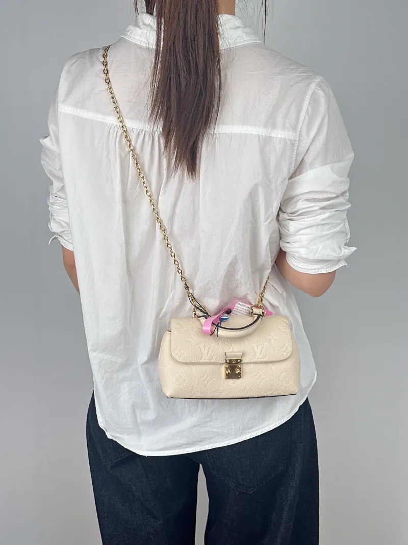 Louis Vuitton Crossbody Bag MADELEINE White Empreinte Embossed Calfskinnano21 × 6 × 12.5 cm — on-model view 1 of 3