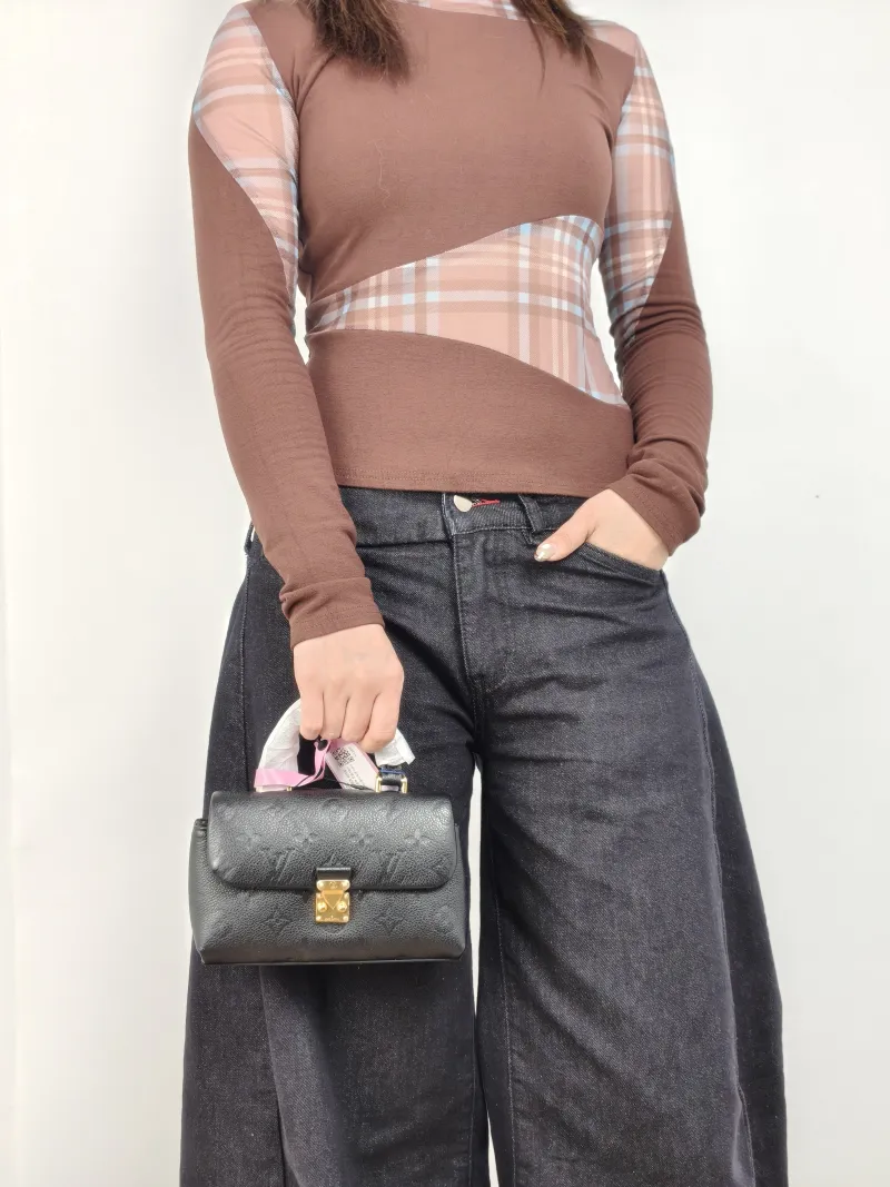 Louis Vuitton Crossbody Bag MADELEINE Black Monogram Empreinte Embossed Calfskin nano 21 × 6 × 12.5 cm — on-model view 2 of 2