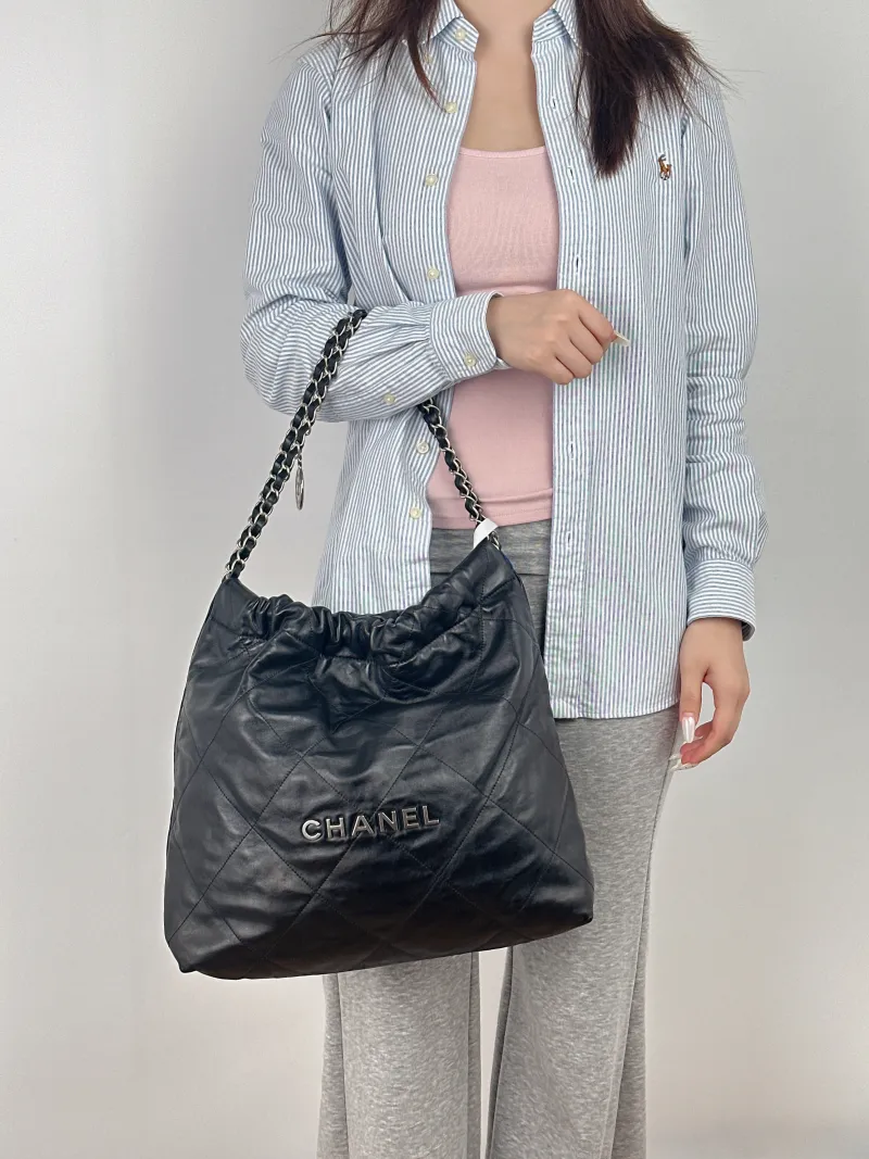 Chanel Shoulder Bag22Bag Black CC alfskin Medium39 × 8 × 42 cm — on-model view 1 of 2