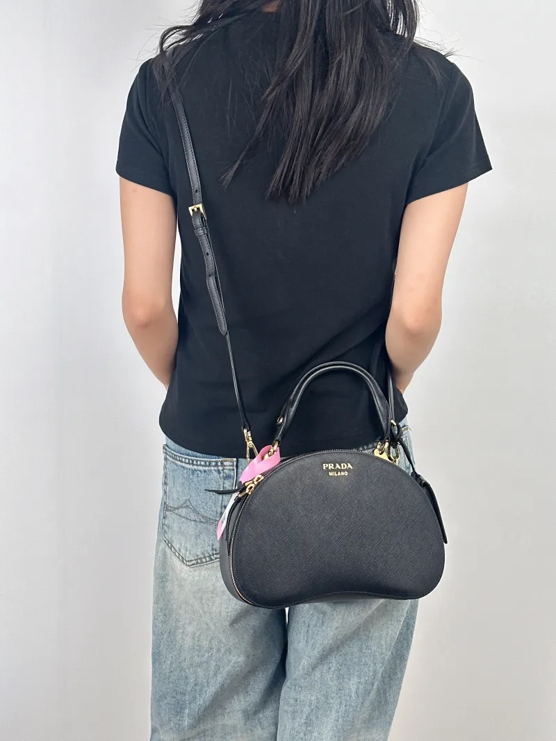 PRADA Shoulder Bag Black Calfskin One Size25 × 8 × 16 cm — on-model view 1 of 3