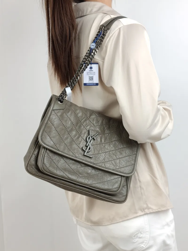 SAINT LAURENT Crossbody Bag Niki D Waxed Leather Medium 28 × 8.5 × 20 cm — on-model view 1 of 2