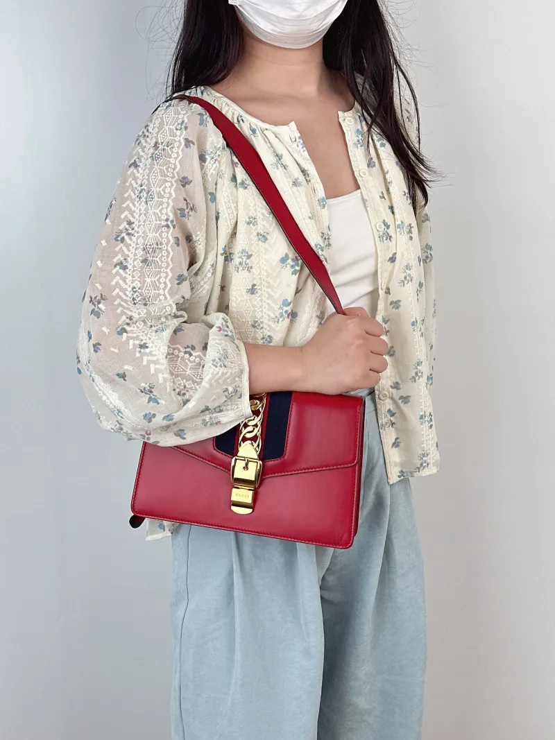 GUCCI Crossbody Bag Sylvie Shoulder Strap Edition Red Calfskin Small25.5 × 8 × 17 cm — on-model view 1 of 2