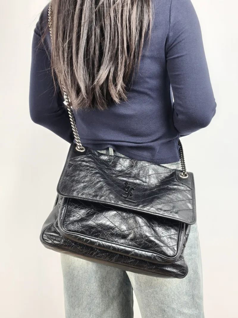 SAINT LAURENT Crossbody Bag Niki Black Calfskin Large 32 × 9 × 23 cm — on-model view 2 of 2