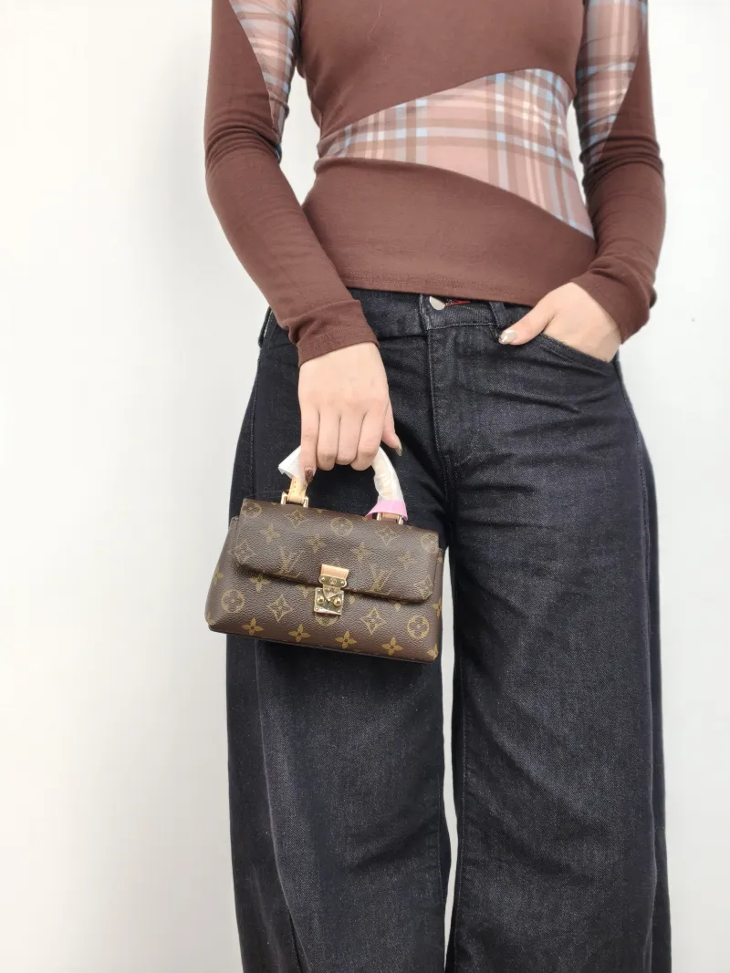 Louis Vuitton Crossbody Bag MADELEINE Monogram PVC nano 21 × 6 × 12.5 cm — on-model view 1 of 3