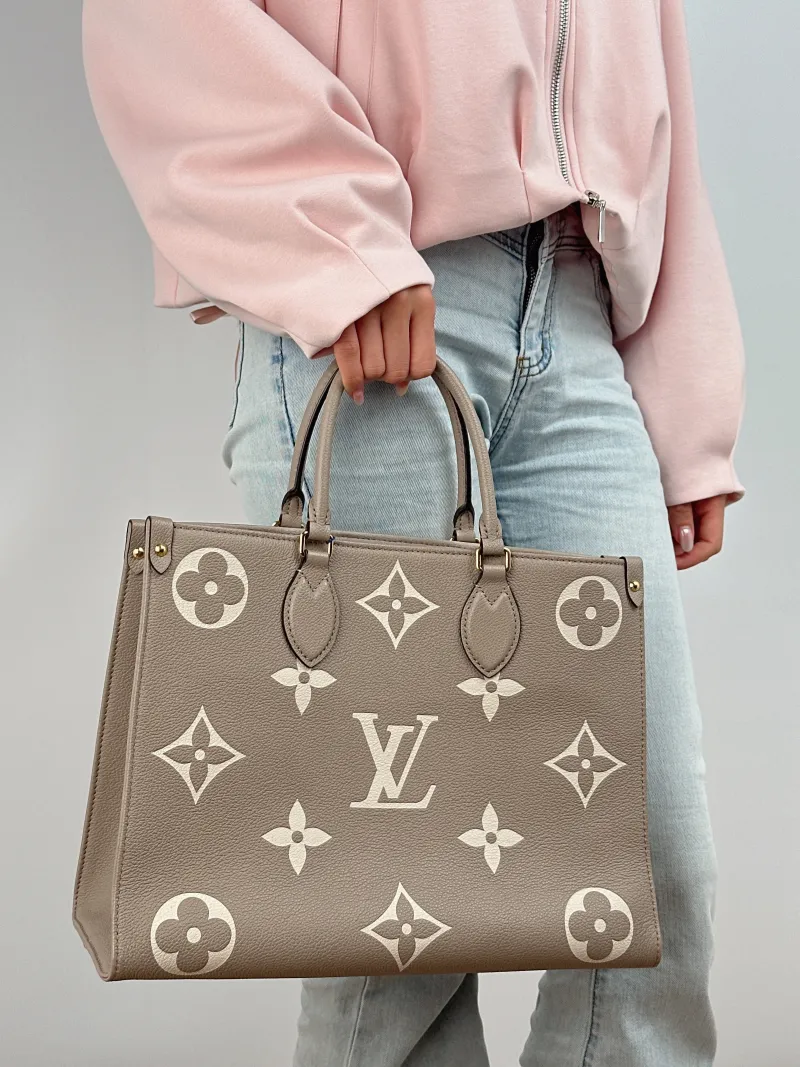 Louis Vuitton Shoulder Bag Onthego Medium · White Monogram Empreinte Embossed Calfskin Medium 35 × 14 × 27 cm — on-model view 2 of 2