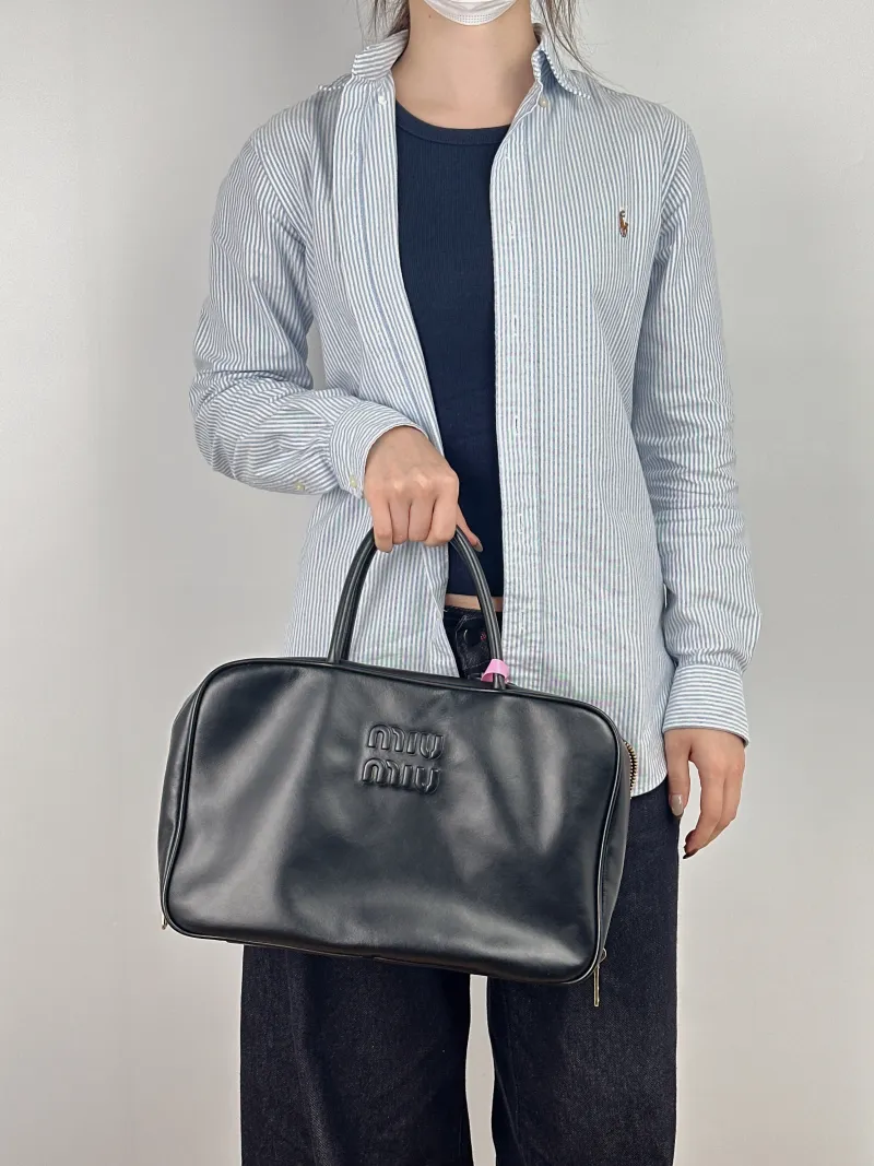 Miumiu Top Handle Bag Beau Black Calfskin Large 34 × 10 × 23 cm — on-model view 1 of 2