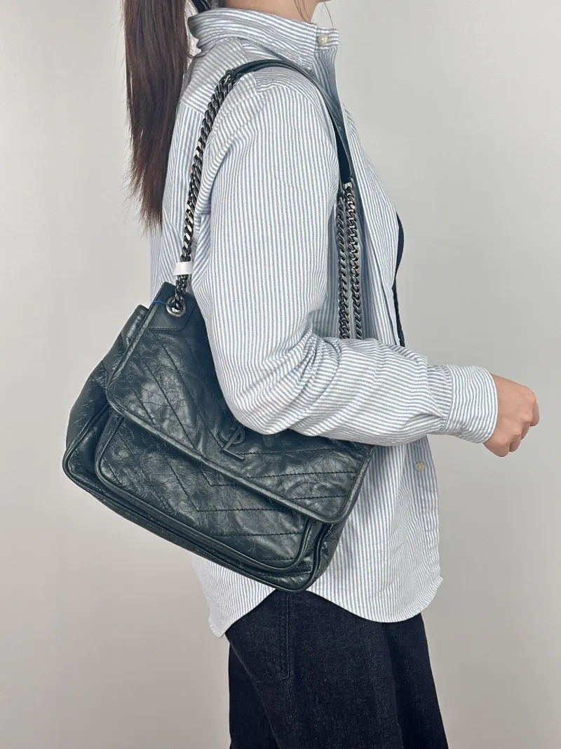 SAINT LAURENT Crossbody Bag Niki Green Waxed Leather Medium 28 × 8.5 × 20 cm — on-model view 2 of 2