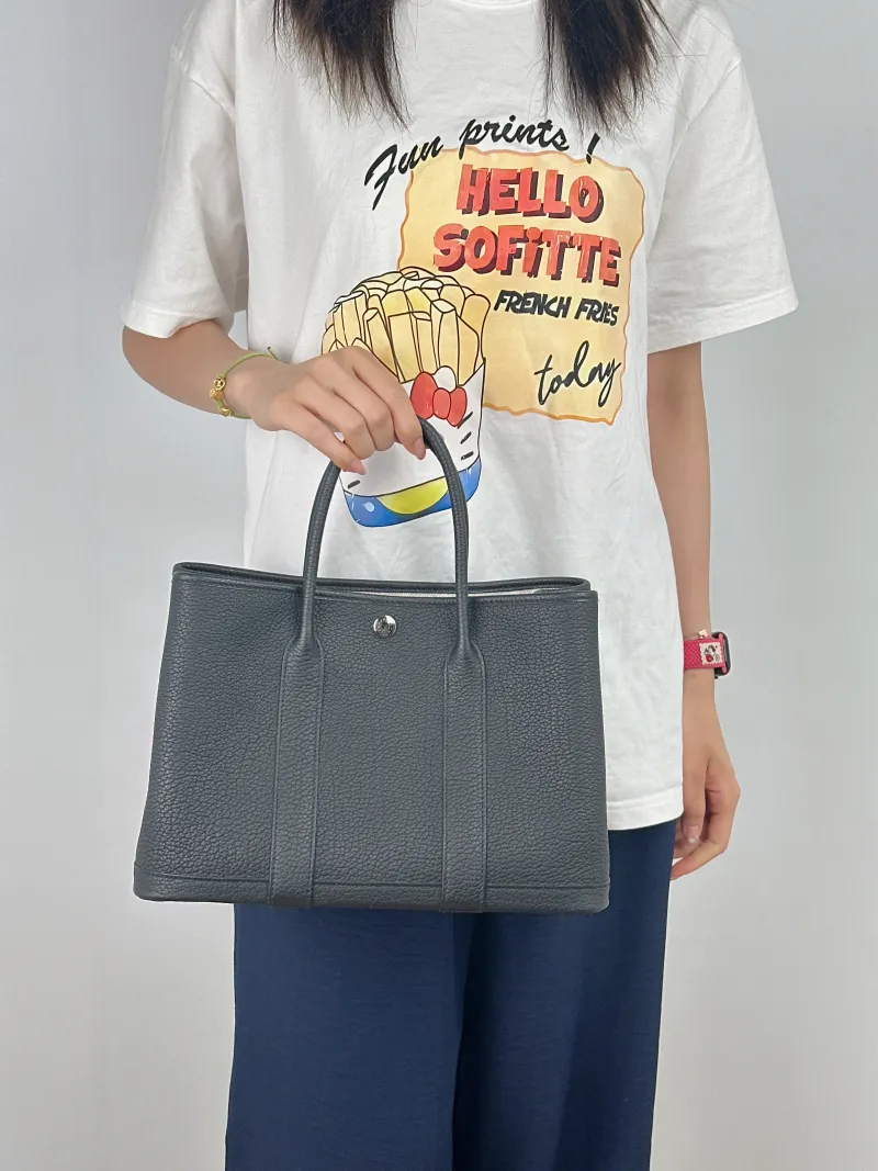 Hermès Top Handle Bag Garden Party 30 30Black Negonda Calfskin Medium30 × 13 × 21 cm — on-model view 1 of 2