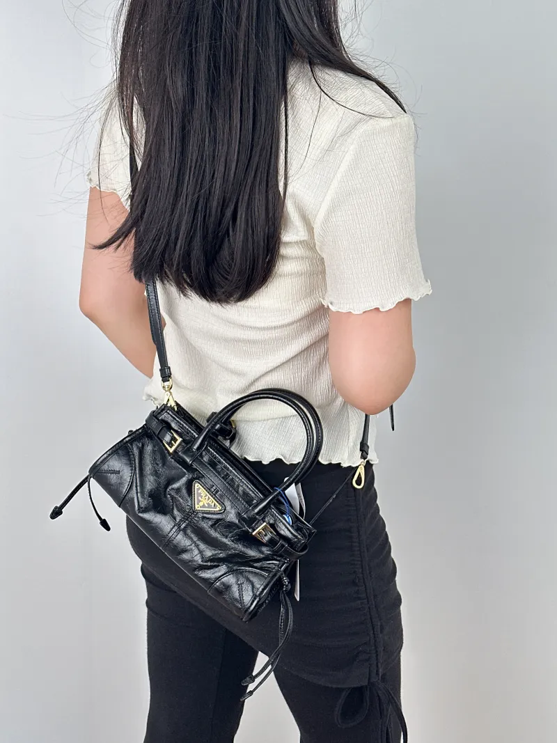 PRADA Shoulder Bag Bonnie Soft Lux Black Waxed Leathermini23.5 × 9 × 12 cm — on-model view 2 of 2