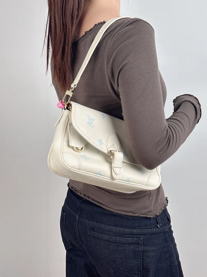Louis Vuitton Crossbody Bag Diane Baguette Bag White · Blue Empreinte Embossed Calfskin Small 24 × 9 × 15 cm — on-model view 1 of 2