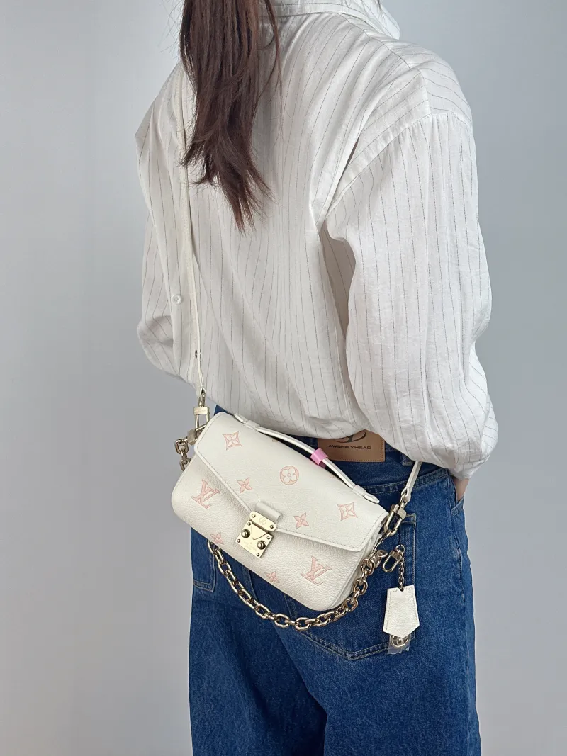 Louis Vuitton Crossbody Bag Pochette Métis East West White · Pink Monogram Empreinte Embossed Calfskin Small 21.5 × 6 × 13.5 cm — on-model view 3 of 3