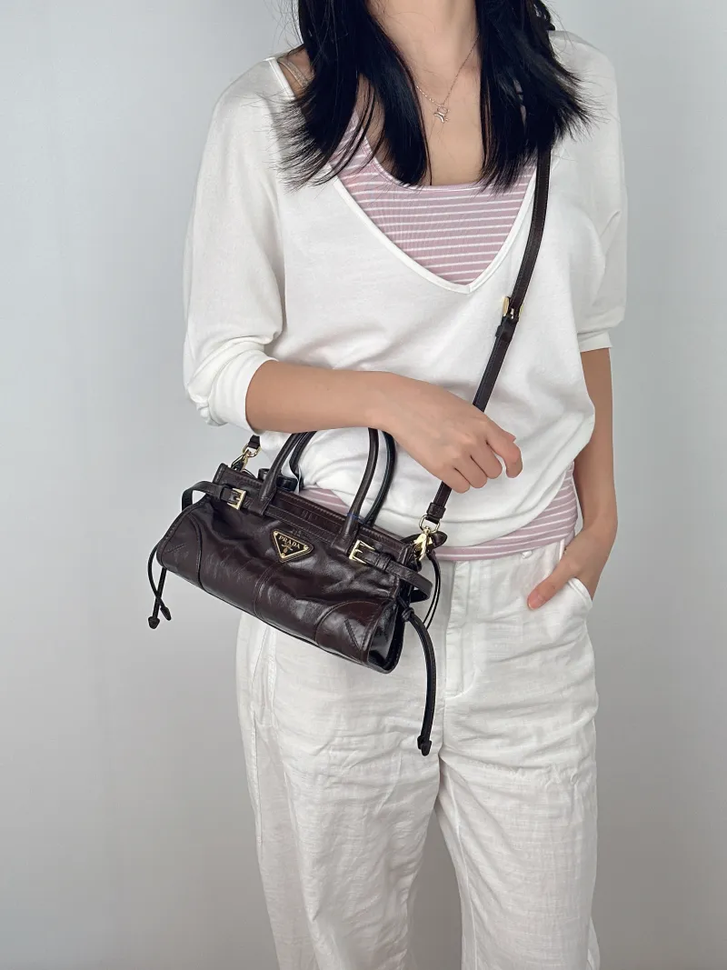 PRADA Top Handle Bag Bonnie Soft Lux Brown Waxed Leathermini23.5 × 9 × 12 cm — on-model view 1 of 3