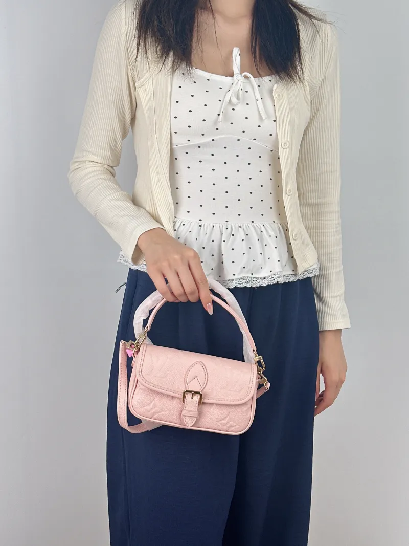 Louis Vuitton Crossbody Bag Diane Baguette Bag Monogram Empreinte Embossed Calfskin nano 19 × 6 × 10.5 cm — on-model view 1 of 2