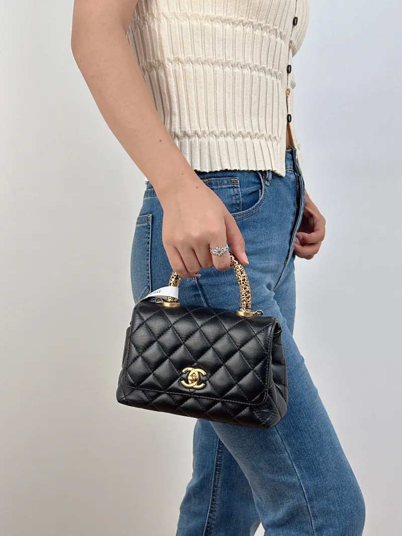 Chanel Top Handle Bag22a Coco Handle​Black CC alfskinmini19 × 9 × 13 cm — on-model view 1 of 2
