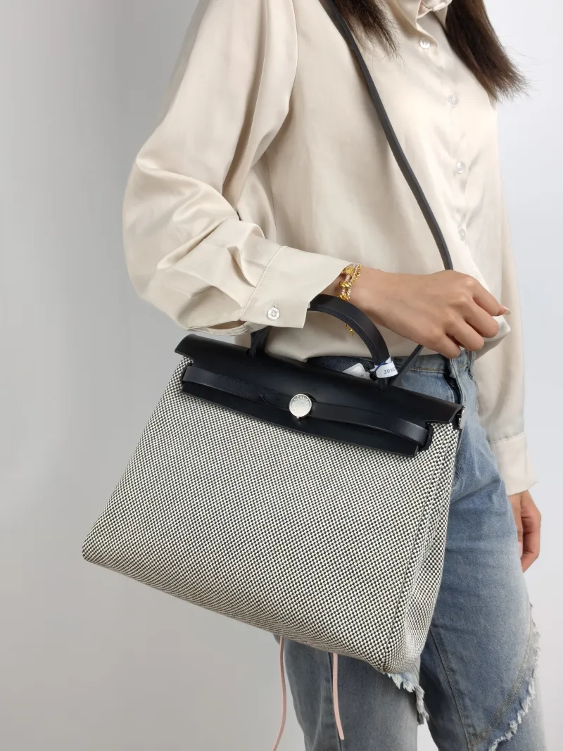 Hermès Crossbody Bag Herbag 31 Black · White Canvas Medium 30.5 × 11 × 25.5 cm u — on-model view 1 of 2