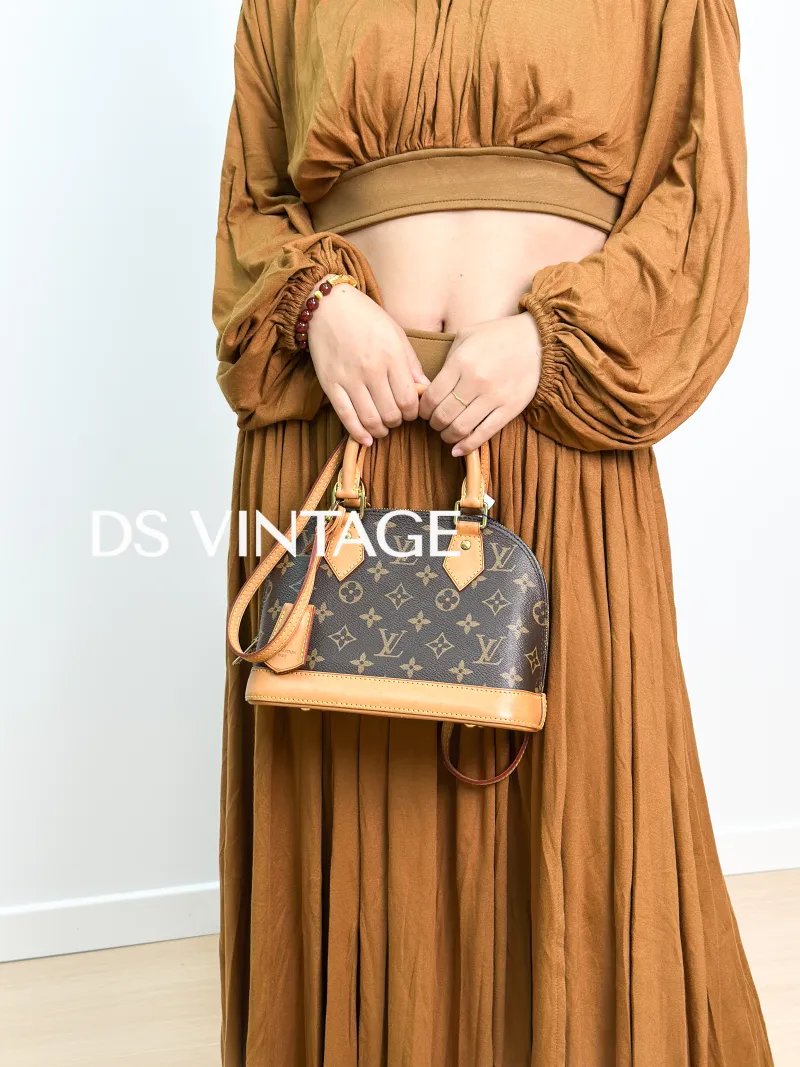 Louis Vuitton Crossbody Bag Alma BB Monogram PVCBB23.5 × 11.5 × 17.5 cm — on-model view 2 of 3