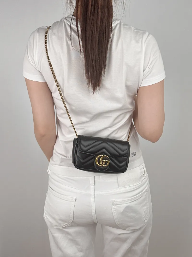 GUCCI Crossbody Bag GG Marmont Mini Marmont Mini Black with Gold-Tone Hardware Calfskinmini16.5 × 4.5 × 9.5 cm — on-model view 2 of 2