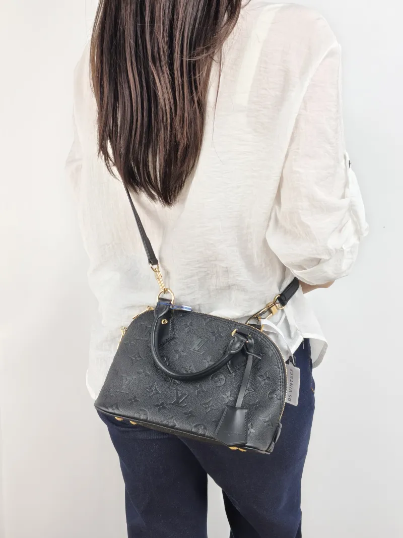 Louis Vuitton Top Handle Bag Alma BB Black Calfskin BB 23.5 × 11.5 × 17.5 cm — on-model view 1 of 2