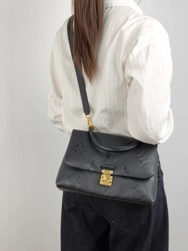 Louis Vuitton Crossbody Bag MADELEINE Black Monogram Empreinte Embossed Calfskin Medium 30 × 11 × 19.5 cm — on-model view 1 of 3