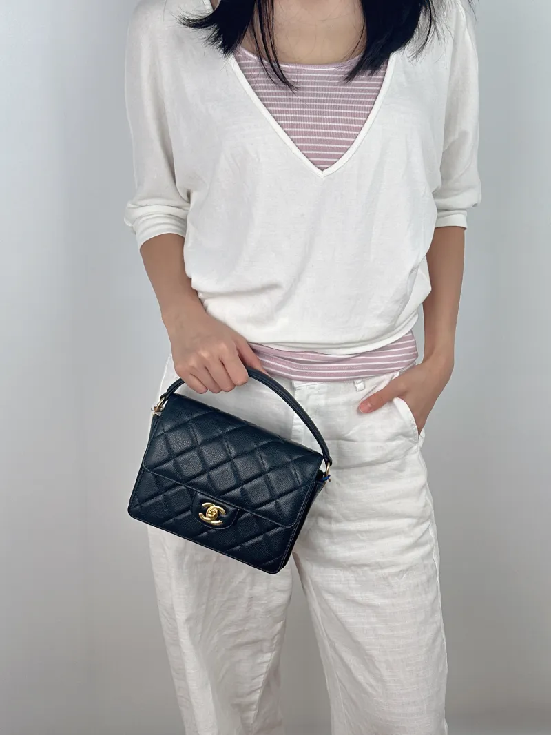 Chanel Crossbody Bag Black with Gold-Tone Hardware Grained Calfskin Small 20 × 5 × 15 cm — on-model view 2 of 3