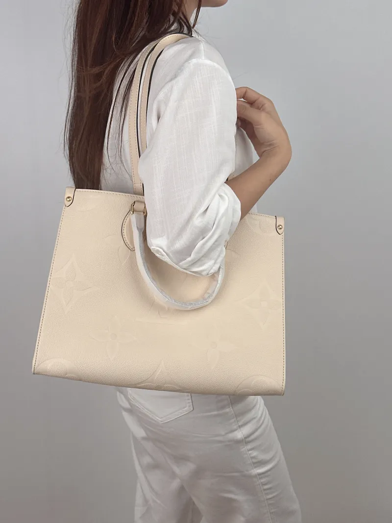 Louis Vuitton Shoulder Bag Onthego Medium White Empreinte Embossed Calfskin Medium 35 × 14 × 27 cm — on-model view 1 of 2