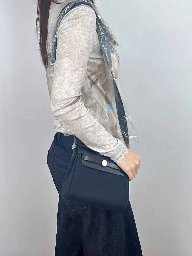 Hermès Crossbody Bag Herbag Zip 2089Black Calfskin，Canvasmini20.5 × 7 × 16.5 cm — on-model view 2 of 2
