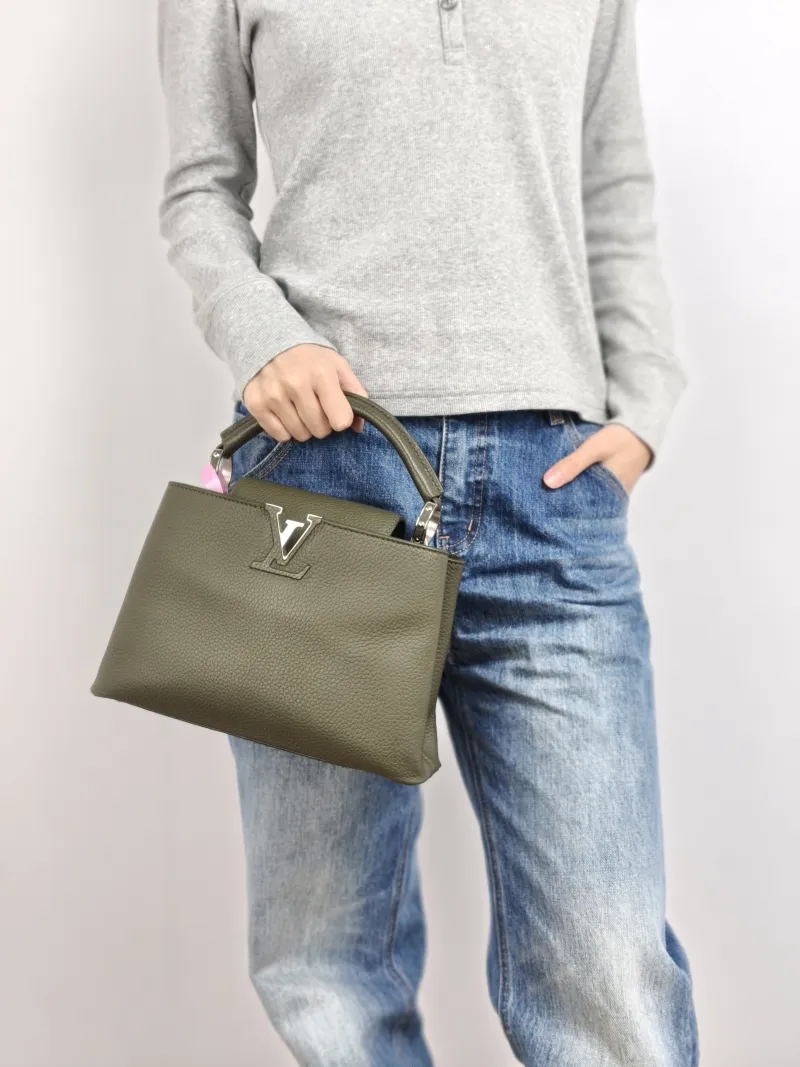 Louis Vuitton Top Handle Bag Capucines Calfskin BB 27 × 9 × 17.5 cm — on-model view 1 of 3