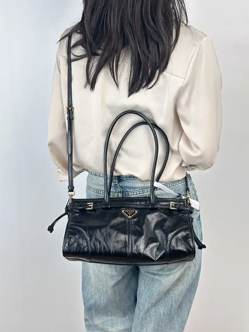 PRADA Shoulder Bag Bonnie Soft Lux Black Waxed Leather Medium32 × 12 × 15.5 cm — on-model view 1 of 5