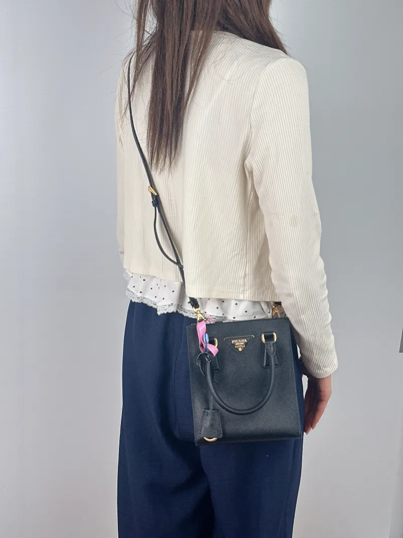 PRADA Top Handle Bag Saffiano Black Calfskin One Size 17 × 6 × 19 cm — on-model view 1 of 3