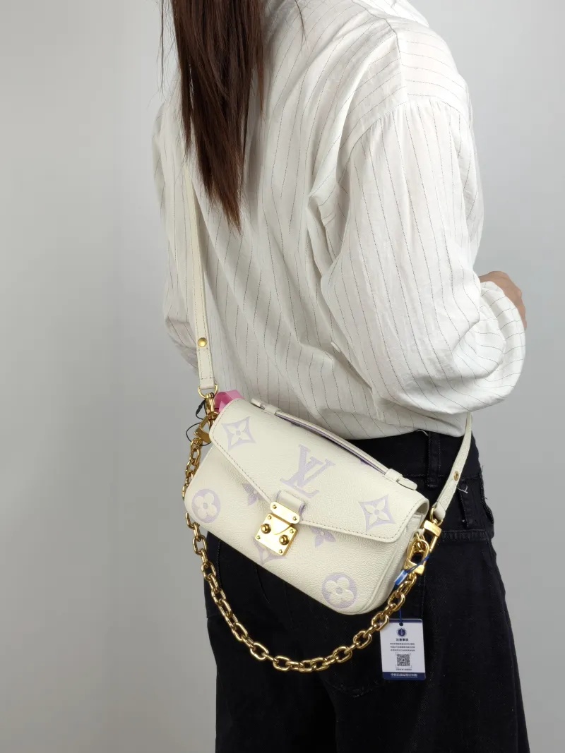 Louis Vuitton Crossbody Bag Pochette Métis East West White · Monogram Empreinte Embossed Calfskin Small 21.5 × 6 × 13.5 cm — on-model view 1 of 3