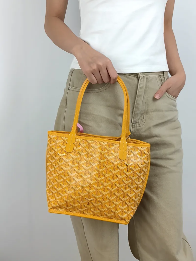 GOYARD Top Handle Bag ANJOU Shopping Tote Yellow PVC Mini 19.5 × 9 × 19.5 cm — on-model view 2 of 3