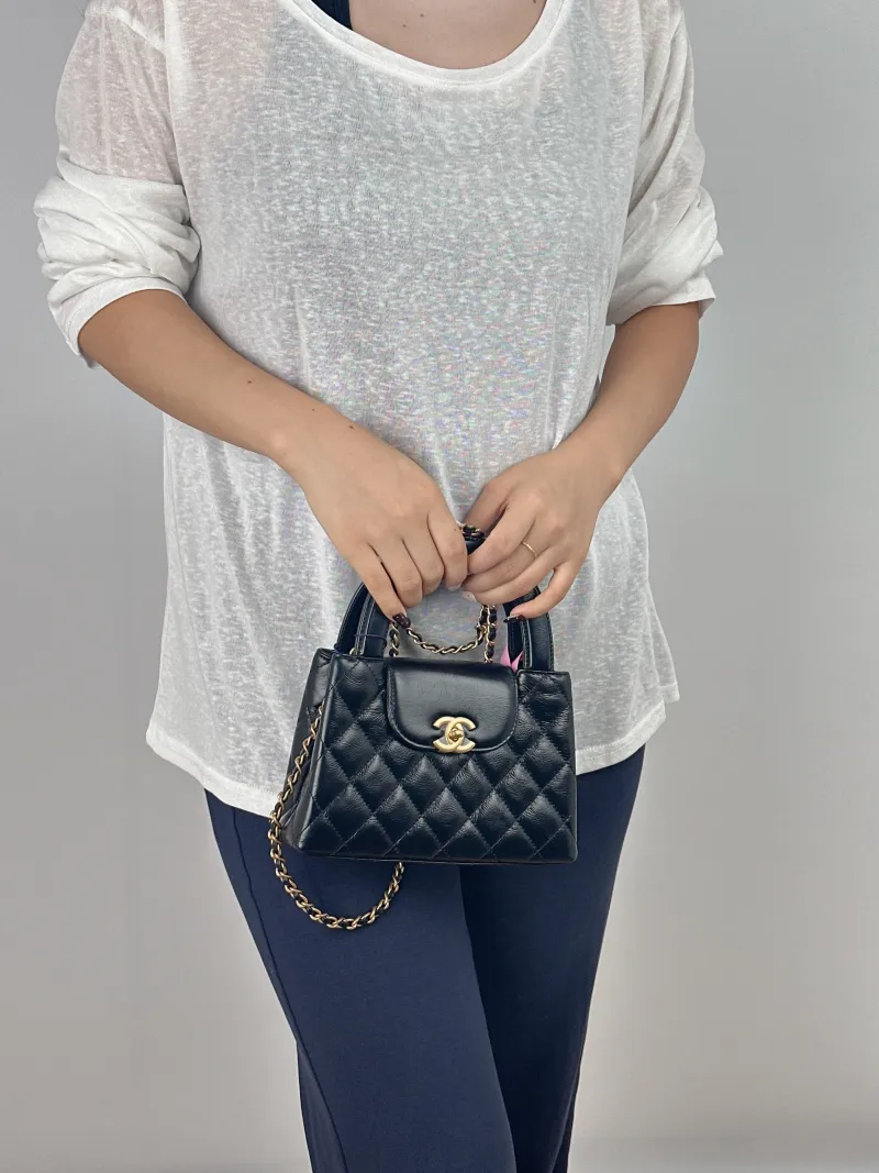 Chanel Crossbody Bag Kelly Black Waxed Leather Mini 19 × 7 × 13 cm — on-model view 1 of 2