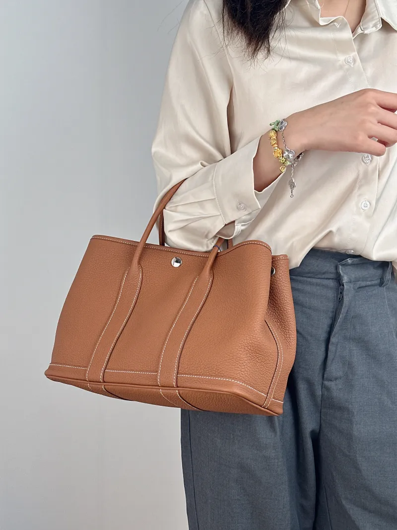 Hermès Top Handle Bag Garden Party 30 30 Negonda Calfskin Medium 30 × 13 × 21 cm K — on-model view 1 of 2