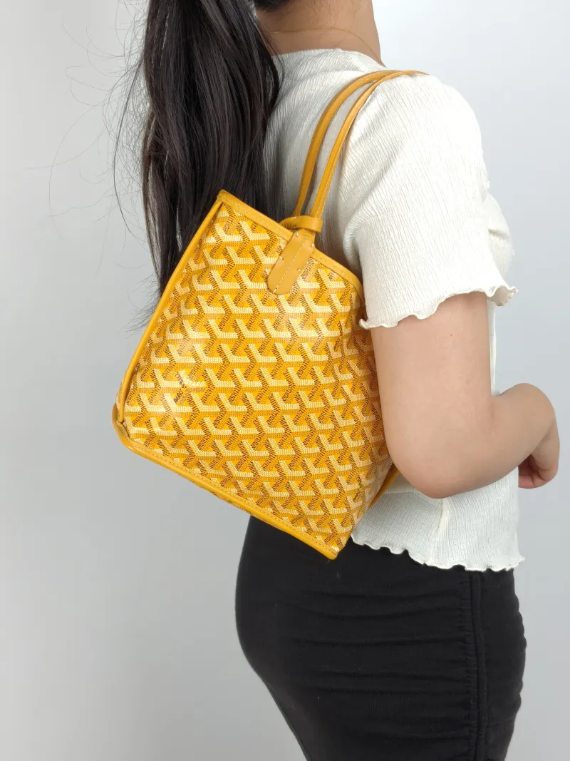 GOYARD Top Handle Bag ANJOU Shopping Tote Yellow PVC Mini 19.5 × 9 × 19.5 cm — on-model view 1 of 2