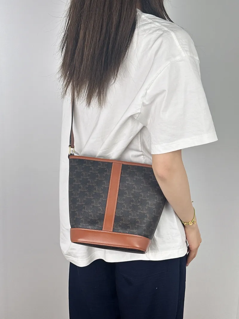 CELINE Crossbody Bag Triomphe Bucket Bag Monogram PVC Small22 × 13 × 26 cm — on-model view 1 of 2