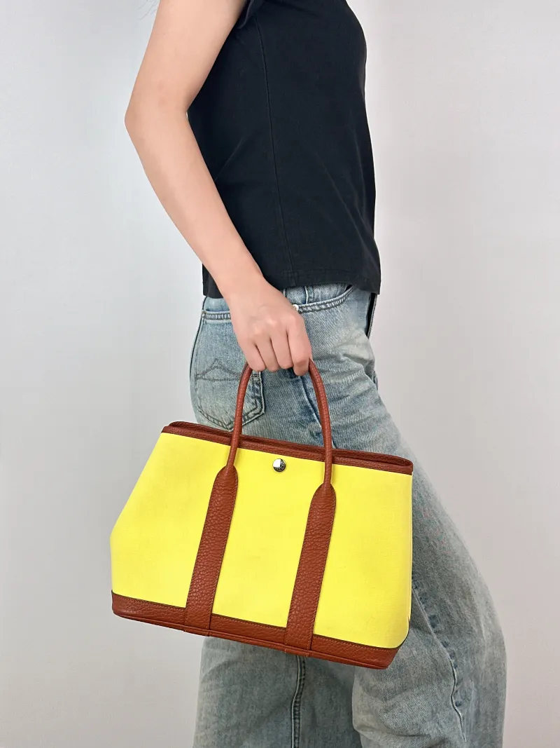 Hermès Top Handle Bag Garden Party 30 30 Canvas · Negonda Calfskin Medium30 × 13 × 21 cm — on-model view 2 of 2