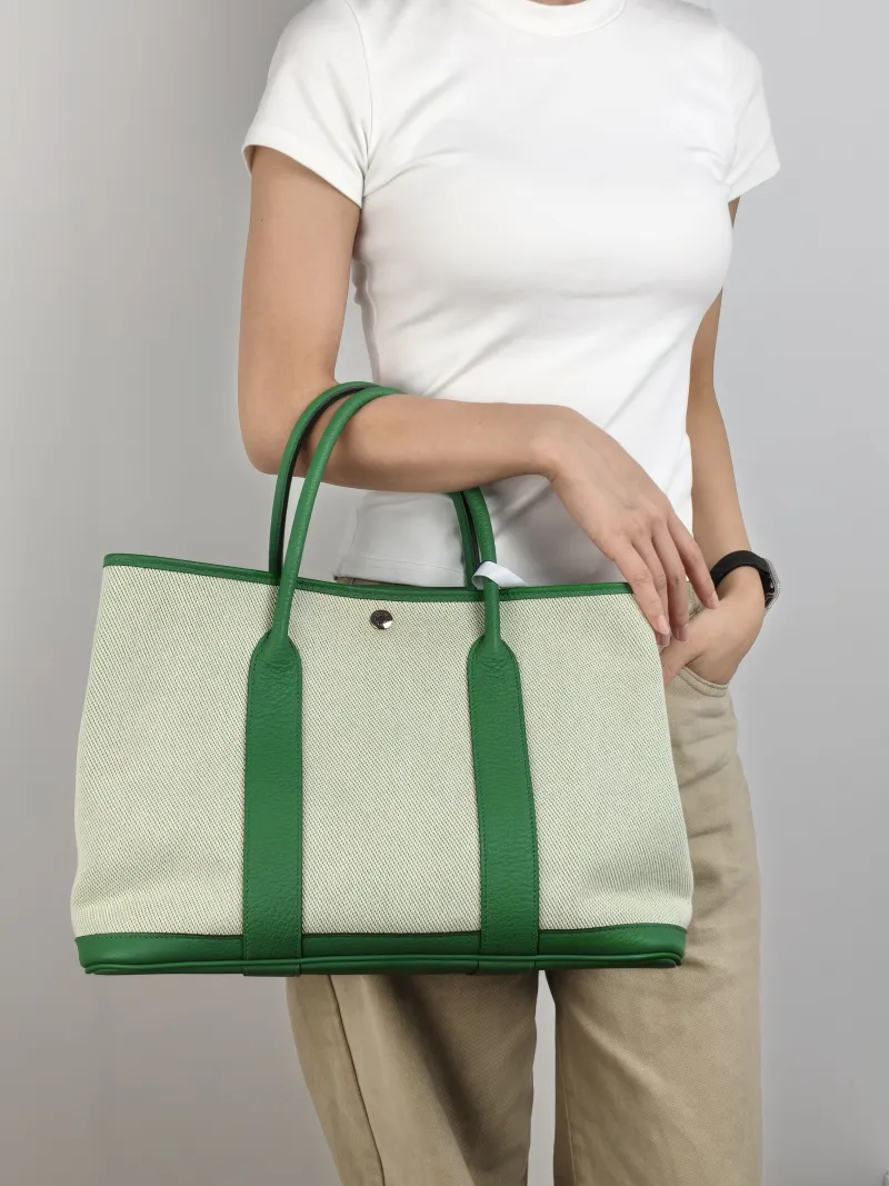 Hermès Top Handle Bag Garden Party 36 36 Beige Canvas · Calfskin Large 36 × 17 × 26 cm R — on-model view 2 of 2