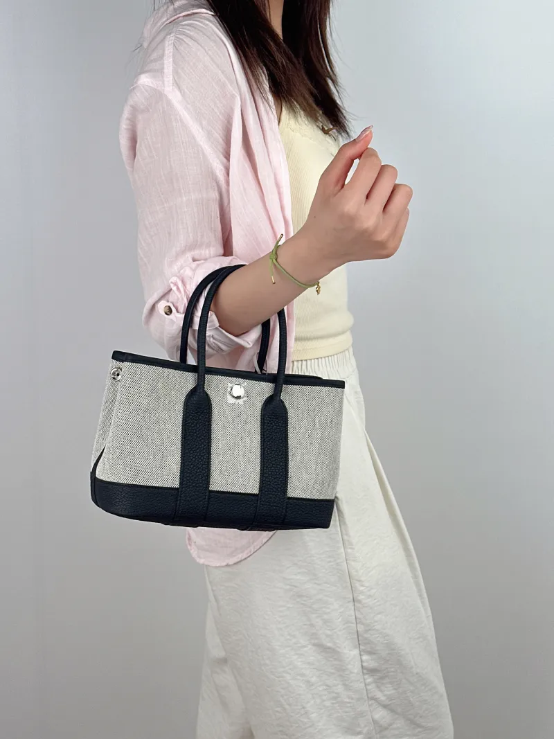 Hermès Top Handle Bag Neo Garden 23 Mini Black · Beige Canvas · Negonda Calfskinmini23 × 10 × 16 cm — on-model view 2 of 2