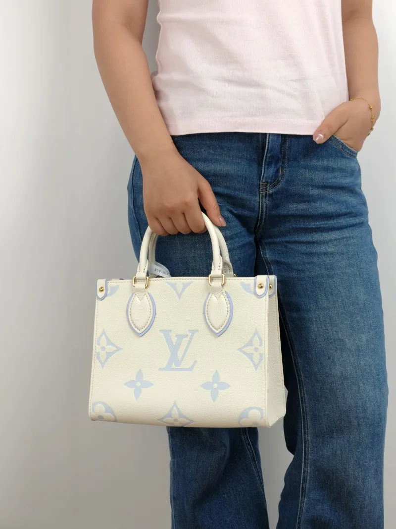 Louis Vuitton Shoulder Bag Onthego White · Blue Monogram Empreinte Embossed Calfskin Small 25 × 11.5 × 19 cm — on-model view 2 of 2
