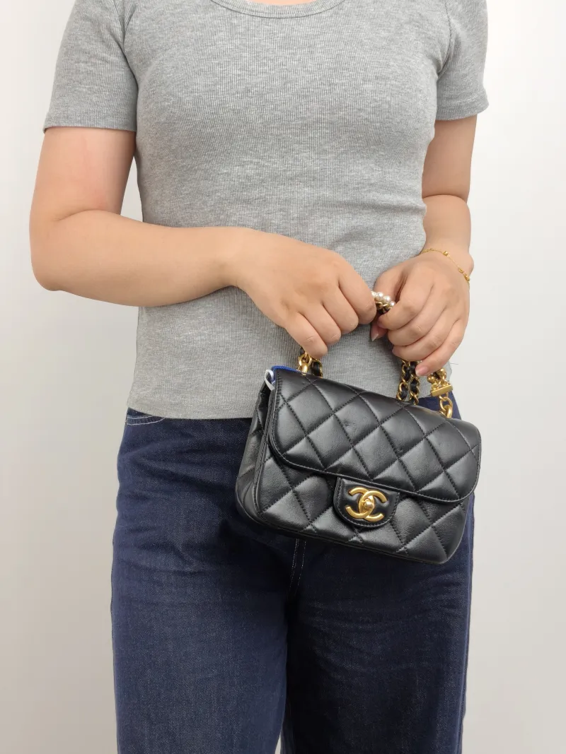 Chanel Crossbody Bag 26c Pearl Black Lambskin Small 20 × 6 × 14 cm — on-model view 1 of 3