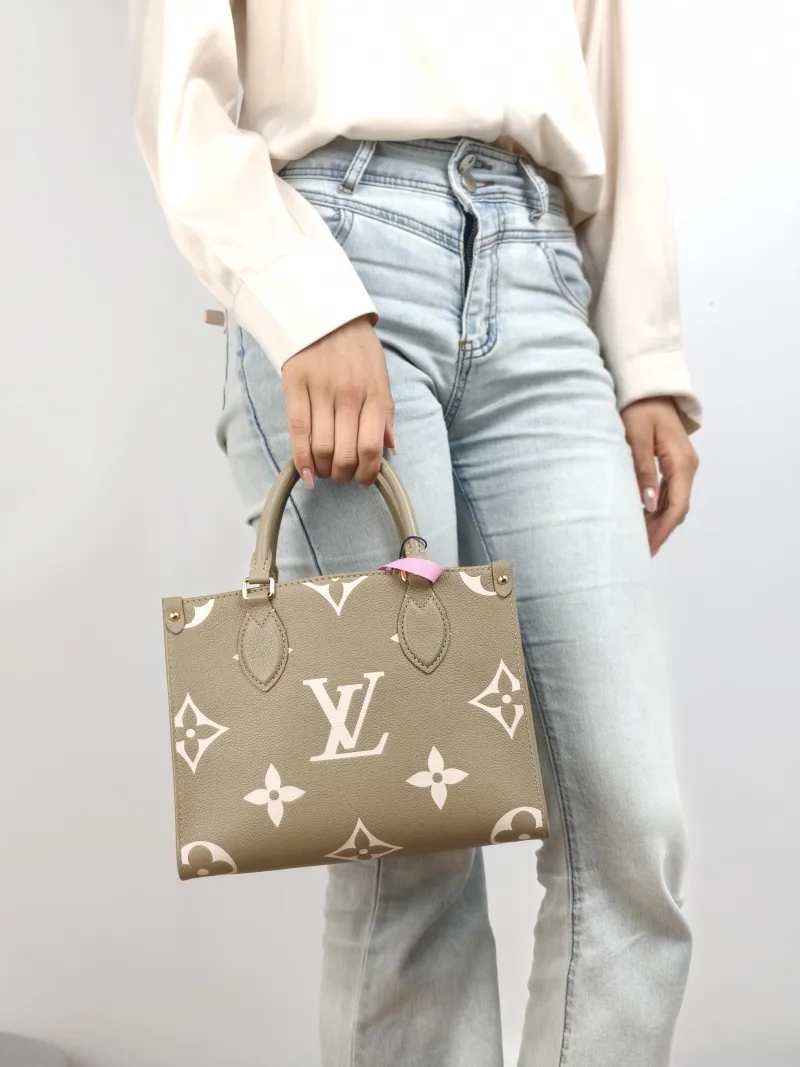 Louis Vuitton Top Handle Bag Onthego Monogram Empreinte Embossed Calfskin Small 25 × 11.5 × 19 cm — on-model view 2 of 2