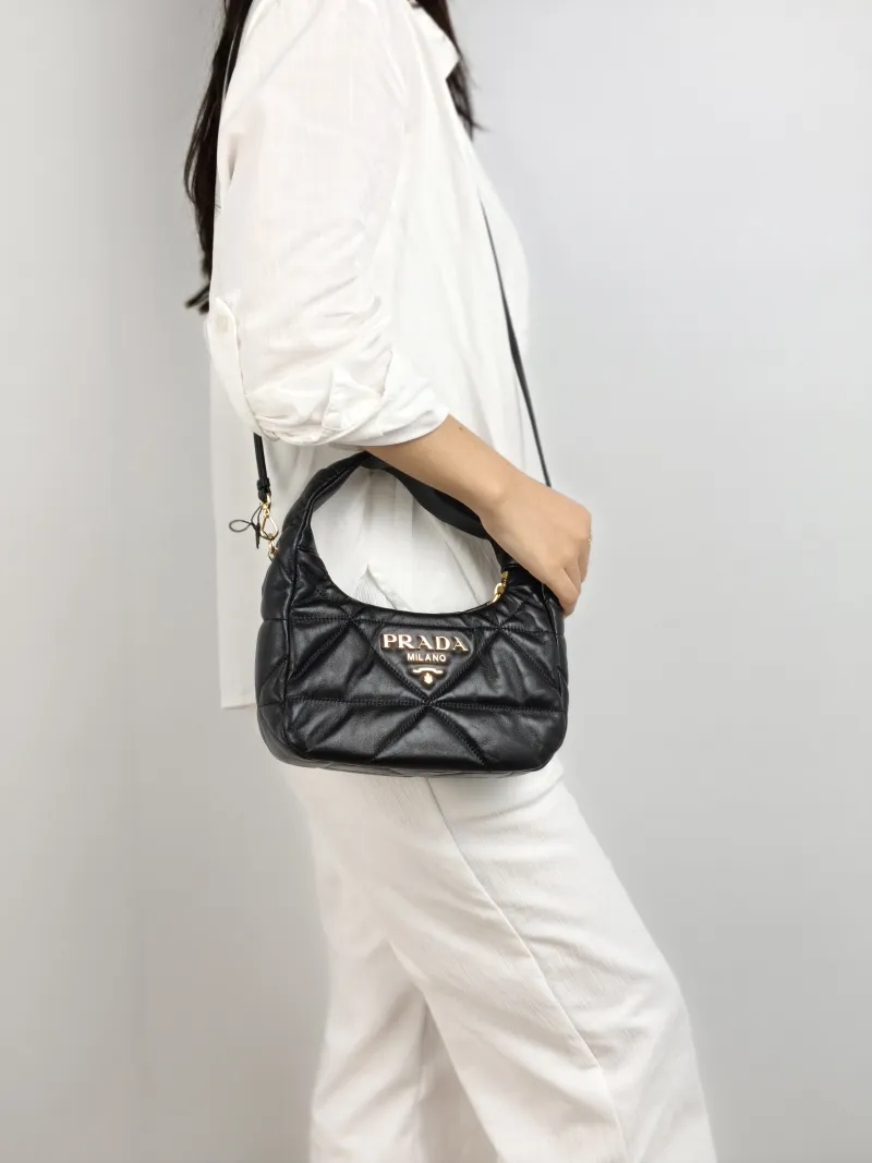 PRADA Shoulder Bag Re-Edition Black Lambskin 22 × 8 × 16 cm — on-model view 1 of 3