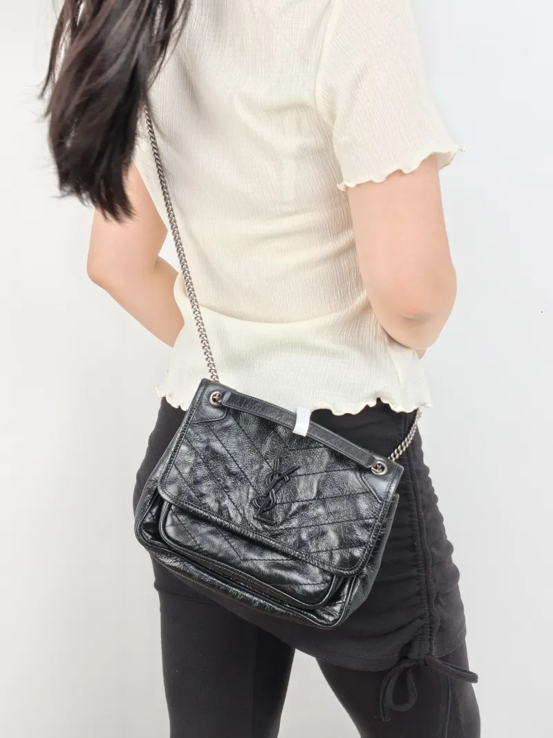 SAINT LAURENT Crossbody Bag Niki Black Waxed Leather Calfskin Small 21 × 7.5 × 16 cm — on-model view 2 of 2