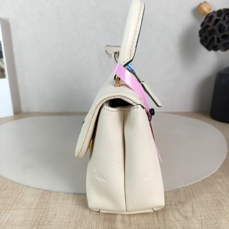 Louis Vuitton Crossbody Bag MADELEINE Beige Monogram Empreinte Embossed Calfskin BB 24 × 8.5 × 17 cm — detail view 12 of 12