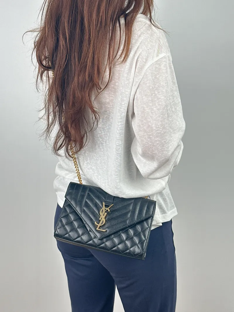 SAINT LAURENT Crossbody Bag ENVELOPE Black Grained Calfskin Small 21 × 6 × 13 cm — on-model view 1 of 2