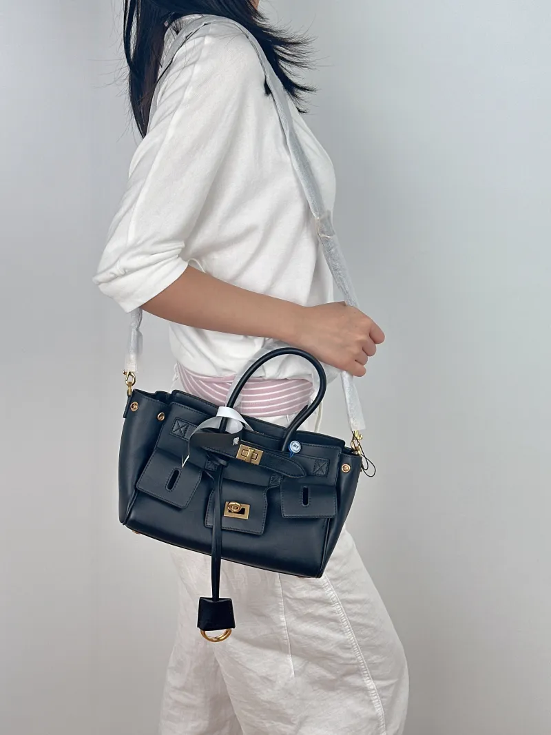 BALENCIAGA Crossbody Bag Bel air Black with Gold-Tone Hardware Calfskin Mini 23.5 × 8 × 17 cm — on-model view 2 of 3