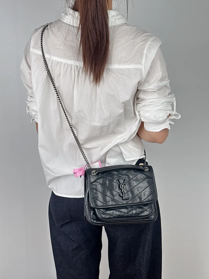 SAINT LAURENT Crossbody Bag Niki D Waxed Leather Calfskin Small21 × 7.5 × 16 cm — on-model view 1 of 2