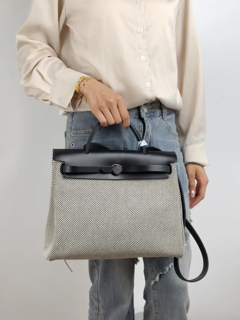 Hermès Crossbody Bag Herbag 31 Black · White Canvas Medium 30.5 × 11 × 25.5 cm u — on-model view 2 of 2